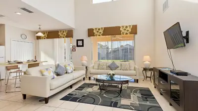 a living room with two couches and a tv at Palm Key Villa 7 bed on Emerald Island Resort in Kissimmee