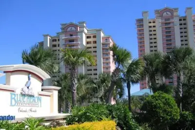 a resort with palm trees in front of tall buildings at Beautiful Apartment close to Disney, fully equipped Amazing lake views in Orlando