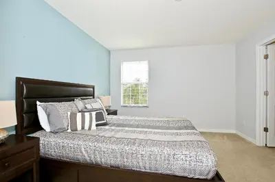 a bedroom with a bed and a window at Spectacular big house, 4 Bedrooms, private pool in Kissimmee