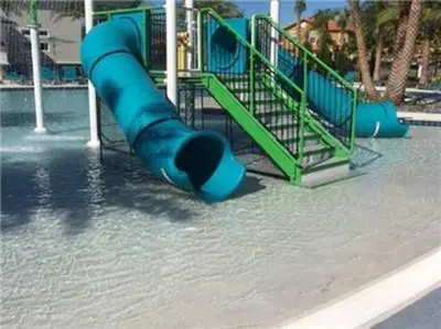 a playground with a blue slide in the water at Spectacular big house, 4 Bedrooms, private pool in Kissimmee