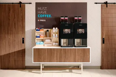 a coffee shop with a counter with a coffee maker on it at Holiday Inn Express Hotel & Suites Orlando - Apopka by IHG in Orlando