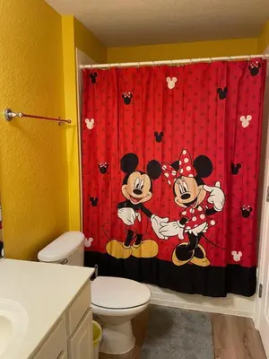 a bathroom with a mickey mouse shower curtain at Windsor Hills Resort 5BR Villa, Amenities, Private Pool & Water Park, Near Disney, Sea World, Universal in Orlando
