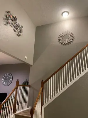a staircase with a mirror and a clock on the wall at Windsor Hills Resort 5BR Villa, Amenities, Private Pool & Water Park, Near Disney, Sea World, Universal in Orlando