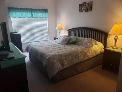 a bedroom with a bed with two lamps and a window at Kissimmee 3bed Villa Near Disney in Kissimmee