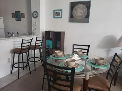 a dining room with a glass table and chairs at Kissimmee 3bed Villa Near Disney in Kissimmee
