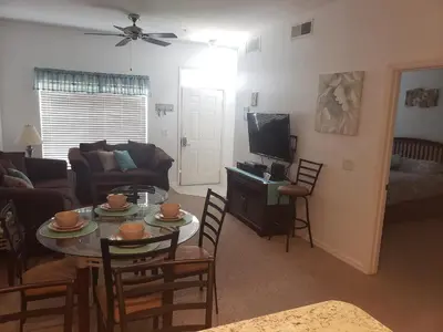 a living room with a table and a tv at Kissimmee 3bed Villa Near Disney in Kissimmee