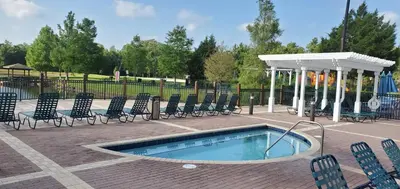 a swimming pool with chairs and a gazebo at Kissimmee 3bed Villa Near Disney in Kissimmee