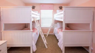a bedroom with two bunk beds and a window at Minnie and Mickeys Mansion - Emerald Island in Kissimmee