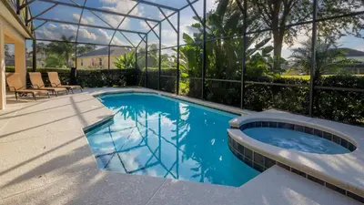 a swimming pool in a building with a glass house at Minnie and Mickeys Mansion - Emerald Island in Kissimmee