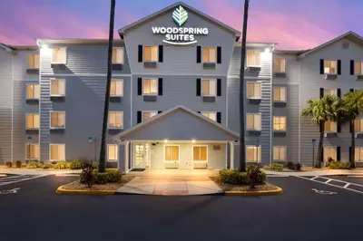 a building with a sign that reads woodworking suite at WoodSpring Suites Orlando North - Maitland in Orlando