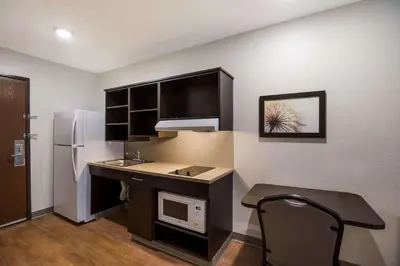 a small kitchen with a sink and a refrigerator at WoodSpring Suites Orlando North - Maitland in Orlando
