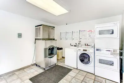 a white laundry room with a washer and dryer at Studio 6 Extended Stay - Kissimmee, FL - Orlando in Orlando