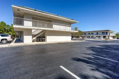 an empty parking lot in front of a building at Studio 6 Extended Stay - Kissimmee, FL - Orlando in Orlando