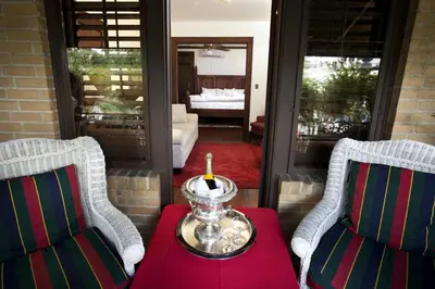 two chairs and a table with a candle on a porch at Park Plaza Hotel Orlando - Winter Park in Orlando