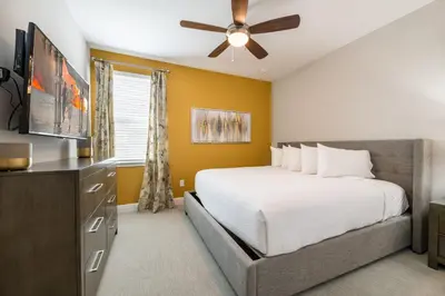 a bedroom with a bed and a ceiling fan at Fabulous Home With Air Hockey, Media Room And Waterpark & Resort Access Near Disney At Encore Resorts Reunion - 290Fl in Kissimmee