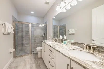 a bathroom with two sinks and a shower at Fabulous Home With Air Hockey, Media Room And Waterpark & Resort Access Near Disney At Encore Resorts Reunion - 290Fl in Kissimmee