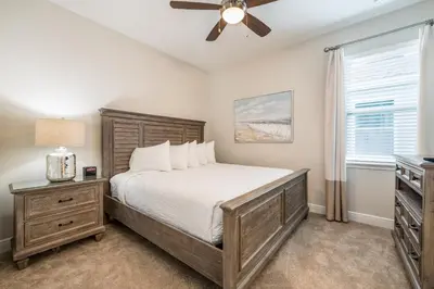 a bedroom with a bed and a ceiling fan at Welcoming Home With Air Hockey Table And Waterpark & Resort Access Near Disney At Encore Resorts Reunion - 321Bu in Kissimmee