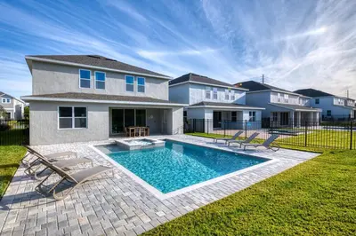 a house with a swimming pool in the yard at Cozy Home With Private Pool, Air Hockey Table And Themed Room Near Disney With Waterpark & Resort Access At Encore Resort - 7458Mr in Kissimmee