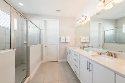 a white bathroom with a shower and a sink at Cozy Home With Private Pool, Air Hockey Table And Themed Room Near Disney With Waterpark & Resort Access At Encore Resort - 7458Mr in Kissimmee