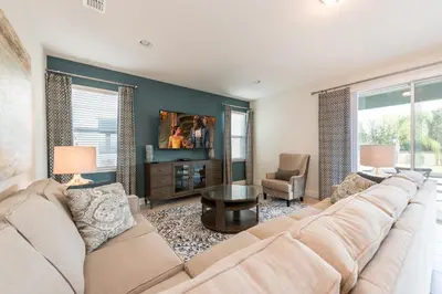 a living room with a large couch and a table at Lovely Home With Private Pool And Air Hockey Table Near Disney With Waterpark & Resort Access At Encore Resort - 7467Mr in Kissimmee