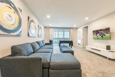 a living room with a couch and a tv at Remarkable Home Near Disney With Theater & Themed Rooms With Waterpark & Resort Access At Encore Resort - 7660Ff in Kissimmee