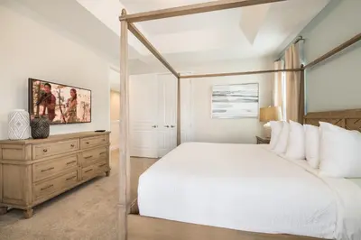 a bedroom with a white bed and a wooden dresser at Cozy Home With Private Pool, Air Hockey Table Near Disney With Waterpark & Resort Access At Encore Resort - 7702Gr in Kissimmee