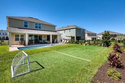 a yard with a soccer goal in front of a house at Chic Home With Mini Soccer Field, Golf Near Disney With Waterpark & Resort Access At Encore Resort - 7715Ff in Kissimmee