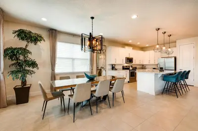 a kitchen and dining room with a table and chairs at Chic Home With Mini Soccer Field, Golf Near Disney With Waterpark & Resort Access At Encore Resort - 7715Ff in Kissimmee