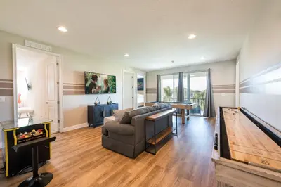 a living room with a couch and a pool table at Spectacular Home With Theater, Theme Rooms Near Disney With Waterpark & Resort Access At Encore Resort - 7734Gr in Kissimmee
