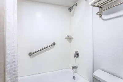a bathroom with a shower and a toilet at Ramada by Wyndham Altamonte Springs Near I-4 in Orlando