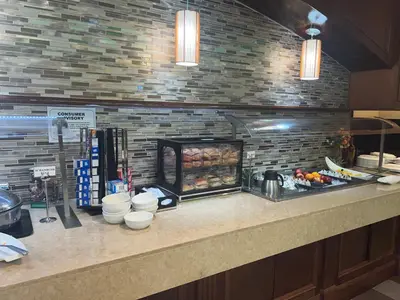 a kitchen with a counter with food on it at Holiday Inn Orlando East-UCF Area by IHG in Orlando