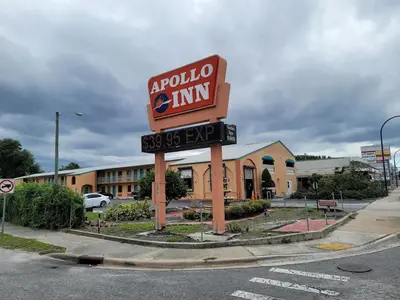 a sign for a rotunda inn in front of a building at Apollo Inn - Downtown in Kissimmee