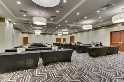 a large room with rows of tables and chairs at Drury Inn & Suites Orlando near Universal Orlando Resort in Orlando
