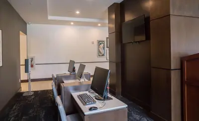 a conference room with a desk with a computer on it at Hyatt Place Orlando/Lake Buena Vista in Orlando