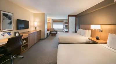 a hotel room with two beds and a television at Hyatt Place Orlando/Lake Buena Vista in Orlando