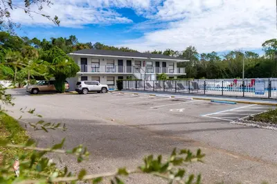 a parking lot in front of a building at Sunshine Inn in Kissimmee