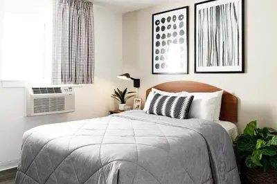 a bedroom with a bed and a window at InTown Suites Extended Stay Select Orlando FL - Lee Rd in Orlando
