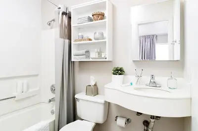 a white bathroom with a sink and a toilet at InTown Suites Extended Stay Select Orlando FL - Lee Rd in Orlando