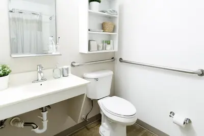 a bathroom with a white toilet and a sink at InTown Suites Extended Stay Orlando FL - South in Orlando