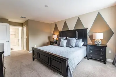 a bedroom with a large bed and two night stands at Enchanting Escape Private Pool SPA Games Room in Orlando