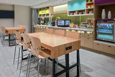 a dining room with a table and chairs in a store at Home2 Suites By Hilton Orlando Near UCF in Orlando