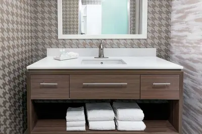 a bathroom with a sink and a mirror at Home2 Suites By Hilton Orlando Near UCF in Orlando