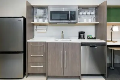 a kitchen with a stainless steel refrigerator and a microwave at Home2 Suites By Hilton Orlando Near UCF in Orlando