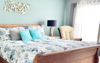 a bedroom with a bed with blue and white sheets at My Disney Castle in Orlando