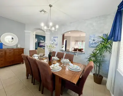 a dining room with a wooden table and chairs at My Disney Castle in Orlando