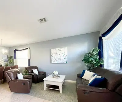 a living room with two couches and a table at My Disney Castle in Orlando