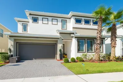 a house with palm trees in front of it at 3830 Premier Villa 6Bd Private Pool and Game Room in Kissimmee