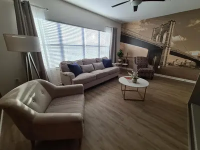a living room with a couch and a table at 3830 Premier Villa 6Bd Private Pool and Game Room in Kissimmee