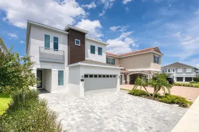 a large house with a driveway and a garage at Luxury Home With Themed Rooms, Air Hockey Near Disney With Waterpark & Resort Access At Encore Resort - 7699Gr in Kissimmee