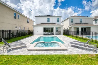 a swimming pool in a yard with two buildings at Luxury Home With Themed Rooms, Air Hockey Near Disney With Waterpark & Resort Access At Encore Resort - 7699Gr in Kissimmee